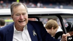 FILE - Former President George H.W. Bush pauses for a photo.