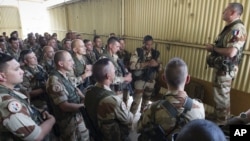 This picture released by the French Army shows French soldiers of the 21st Marine Infantry Regiment during a briefing before flying to Bamako, the capital from Mali, at the N'Djamena airport in Chad, Jan. 11, 2013.