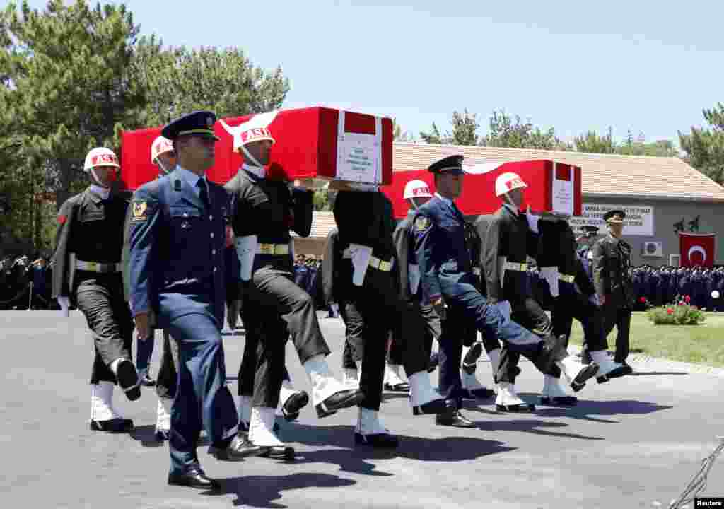 Turkish soldiers carry the coffins of fallen Turkish pilots, Captain Gokhan Ertan and Lieutenant Hasan Huseyin Aksoy, during an official farewell ceremony at the 7th Jet Main Air Base in the eastern Turkish city of Malatya July 6, 2012.