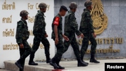 Thai Army officers walk outside the military barracks believed to be holding two arrested bomb suspects involved in the recent Bangkok blast in Bangkok, Thailand, September 2, 2015.