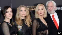 Actors, from left, Jena Malone, Natalie Dormer, Jennifer Lawrence and Donald Sutherland attend a special screening of "The Hunger Games: Mockingjay Part 2," Nov. 18, 2015, in New York. 