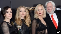 Actors, from left, Jena Malone, Natalie Dormer, Jennifer Lawrence and Donald Sutherland attend a special screening of "The Hunger Games: Mockingjay Part 2," Nov. 18, 2015, in New York. 