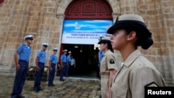 Members of the Colombian navy gather outside a church where President Juan Manuel Santos will attend mass on Monday, before signing a peace agreement with the Revolutionary Armed Forces of Colombia (FARC), in Cartagena, Colombia, September 25, 2016.