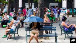 FILE - Users surf the Internet at a Wi-Fi hotspot in Havana, Cuba, Nov. 25, 2015.