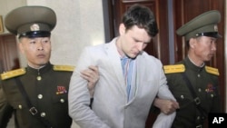 American student Otto Warmbier, center, is escorted at the Supreme Court in Pyongyang, North Korea in March. He was sentenced to 15 years in prison with hard labor.