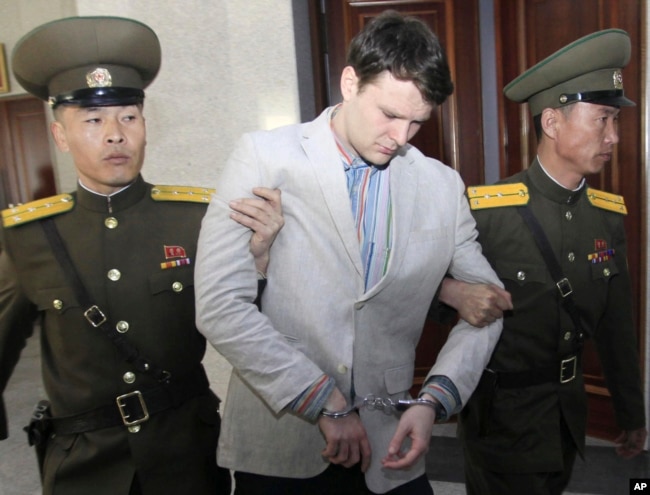 American student Otto Warmbier, center, is escorted at the Supreme Court in Pyongyang, North Korea, Wednesday, March 16, 2016. Warmbier was sentenced to 15 years in prison with hard labor on Wednesday.