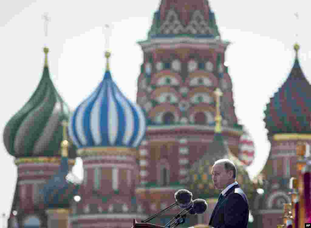 Russian President Vladimir Putin addresses the Victory Parade marking the 70th anniversary of the defeat of the Nazis in World War II, in Red Square, Moscow, Russia, May 9, 2015, with the St. Basil's Cathedral is in the background.