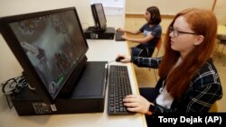 Claire Hofstra and Kaila Morris play "Heroes of the Storm," at Hathaway Brown School, Wednesday, July 10, 2019, in Shaker Heights, Ohio. (AP Photo/Tony Dejak)