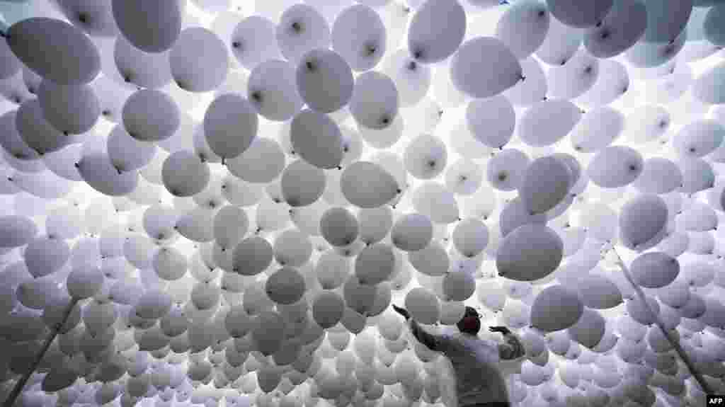 Thousands of biodegradable balloons are released by members of the Chamber of Commerce to celebrate the New Year in Sao Paulo, Brazil.