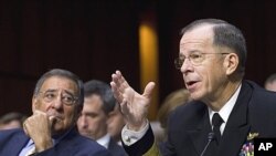 Defense Secretary Leon Panetta looks on as Admiral Michael Mullen testifies before the Senate Armed Services Committee in Washington, September 22, 2011.