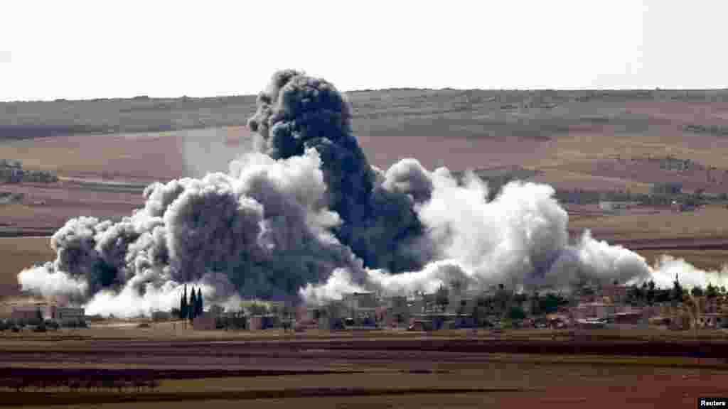 Smoke rises from a village on the outskirts of the Syrian town of Kobani, Oct. 15, 2014. 
