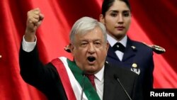 Mexico's new president, Andres Manuel Lopez Obrador, gestures during his inauguration at Congress, in Mexico City, Dec. 1, 2018. 