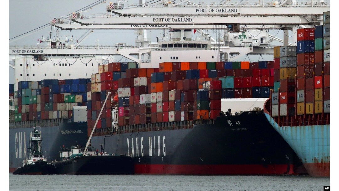 FILE - The Yang Ming shipping line container ship Ym Utmost is unloaded at the Port of Oakland on July 2, 2018, in Oakland, Calif. The Trump administration on July 6 began imposing tariffs on $34 billion worth of Chinese imports.