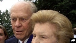 Former U.S. President Gerald Ford and his wife Betty talk to reporters outside the White House in this August 11, 1999 file photo.