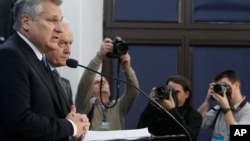 Former Polish President Aleskander Kwasniewski, left, and former Prime Minister Leszek Miller, second left, who were in power when the CIA ran a secret prison in Poland, speak to reporters in Warsaw about a report on CIA techniques, Dec. 10, 2014. (AP Photo/Czarek Sokolowski)