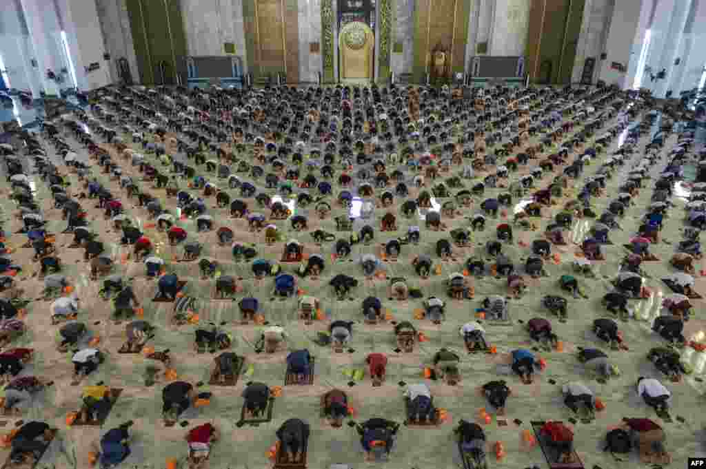 Muslims take part in Friday prayers with social distancing measures in place because of the COVID-19 crisis, at a religious center in Surabaya, Indonesia.