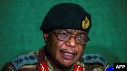 FILE: This file photo taken on November 20, 2017 shows then Zimbabwe's former Commander Defense Forces General Constantino Guveya Chiwenga (C) speaking during a press conference at the Tongogara Barracks, in Harare. 