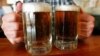 FILE - A bartender serves two mugs of beer at a tavern in Montpelier, Vermont, June 29, 2004.