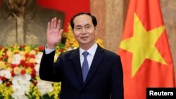  FILE - Vietnamese President Tran Dai Quang greets journalists as he waits for the arrival of Russian Foreign Minister Sergei Lavrov at the Presidential Palace in Hanoi, Vietnam, March 23, 2018.