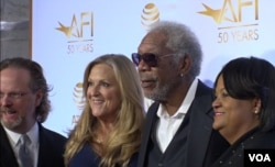 Actor Morgan Freeman (2-R) is seen in a group photo with guests attending an event marking 50 years of joint film preservation efforts between the American Film Institute and the Libary of Congress.