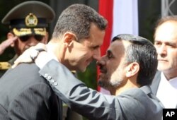 Le président Bashar el-Assad (à g.) accueilli par son homologue iranien Mahmoud Ahmadinejad, en octobre 2010