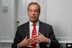 FILE - Former UK Independence Party (UKIP) leader Nigel Farage gestures during an interview with The Associated Press in London, Nov. 29, 2016.