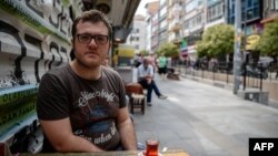 Burak Bulkan, 24, who graduated from Istanbul's Bosphorus University, poses in Istanbul, Aug. 23, 2016. Turkey canceled a major European Union-funded scholarship scheme after the July 15 botched coup bid, leaving in limbo dozens of Turkish students dreami