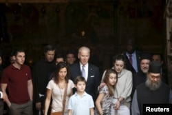U.S. Vice President Joe Biden, center, and his family members stand at the entrance to the Church of Holy Sepulchre in Jerusalem's Old City, March 9, 2016.