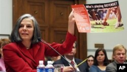 FILE - U.S. Centers for Disease Control (CDC) Director Julie Gerberding holds up a staph awareness poster while testifying before the House Committee on Oversight and Government Reform Committee hearing on drug-resistant infections and the consequences for public health, on Capitol Hill in Washington, November 2007.