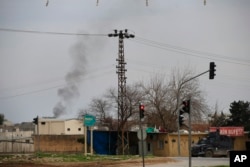 Smoke billows from a fire at the southeastern town of Nusaybin, Turkey, near the border with Syria, where Turkish security forces are battling militants linked to the outlawed Kurdistan Workers, Party or PKK, Sunday, Feb. 14, 2016.