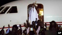 Gambia's defeated leader Yahya Jammeh waves to supporters as he departs from Banjul airport, Jan. 21, 2017. 