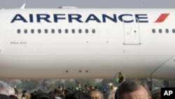 French Transportation Minister Thierry Mariani, right, accompanied by Cambodia Deputy Prime Minister Sok An, left, walk out after the launching ceremony at Phnom Penh International Airport in Phnom Penh, Cambodia, Thursday, March 31, 2011. Air France pass