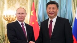 FILE - Russian President Vladimir Putin, left, shakes hands with Chinese President Xi Jinping during a meeting in the Kremlin, in Moscow, Russia, July 4, 2017.