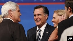 Former Mass. Governor Romney, wife talk to former Speaker of the U.S. House of Representatives Newt Gingrich in Orlando, Sept. 23, 2011.