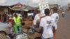 Health workers speak to people on the streets to educate them about the deadly Ebola virus in the city of Freetown, Sierra Leone, Aug. 4, 2014.