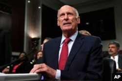 FILE - Director of National Intelligence Dan Coats prepares to testify on Capitol Hill in Washington.