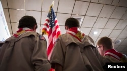 FILE - Boy Scouts stand on stage with a U.S. flag during the Pledge of Allegiance to begin the inaugural Freedom Summit meeting for conservative speakers in Manchester, New Hampshire, April 12, 2014. 