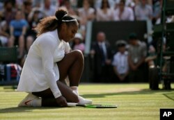 Serena Williams of the United States kneels after losing a point to Germany's Angelique Kerber during their women's singles final match at the Wimbledon Tennis Championships, in London, July 14, 2018.