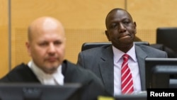 Kenya's Deputy President William Ruto (R) reacts as he sits in the courtroom before his trial at the International Criminal Court (ICC) in The Hague, September 10, 2013. 