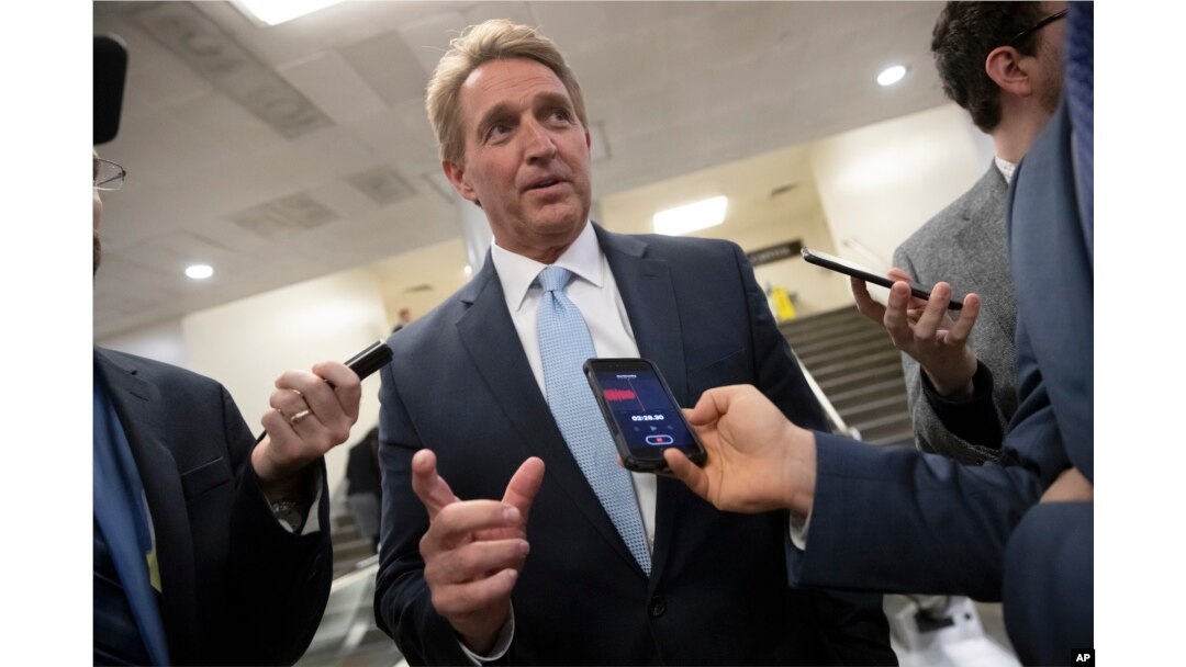 FILE - Sen. Jeff Flake speaks with reporters in Washington, Nov. 14, 2018.