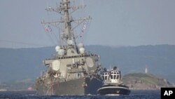 The damaged USS Fitzgerald is towed by a tugboat near the U.S. naval base in Yokosuka, southwest of Tokyo, after the destroyer collided with the Philippine-registered container ship ACX Crystal off the Izu Peninsula, June 17, 2017. 