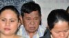 FILE – Powerful Filipino clan leader Andal Ampatuan Sr., center, is arraigned on electoral sabotage charges in 2012. A suspect in the 2009 massacre of at least 57 people, he died in July 2015.