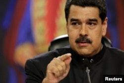 FILE - Venezuela's President Nicolas Maduro talks to the media during a news conference at Miraflores Palace in Caracas, Venezuela, June 22, 2017.