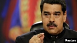 FILE - Venezuela's President Nicolas Maduro talks to the media during a news conference at Miraflores Palace in Caracas, Venezuela, June 22, 2017.