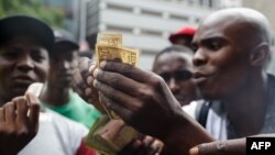 Public transport drivers complain about having to pay for fuel in U.S. dollars at a fuel station, Jan. 11, 2019, in Harare. Motorists are spending nights waiting in long queues for petrol and diesel as the country is experiencing crippling fuel shortages.