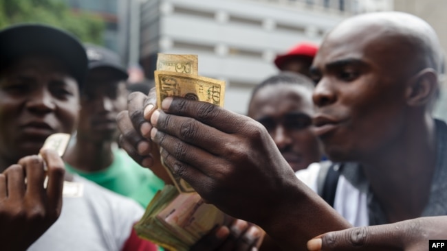 Public transport drivers complain about having to pay for fuel in U.S. dollars at a fuel station, Jan. 11, 2019, in Harare. Motorists are spending nights waiting in long queues for petrol and diesel as the country is experiencing crippling fuel shortages.