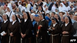 FILE - Nuns attend a mass at Saint John's Lateran Basilica in Rome, Italy, June 4, 2015. 