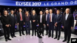 FILE - Candidates in France's presidential race pose for a group photo before a television debate at French private TV channels BFM TV and CNews, in La Plaine-Saint-Denis, outside Paris, April 4, 2017. 