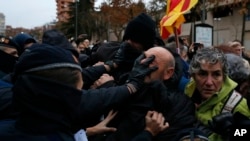 Catalan officers struggle with demonstrators around Lleida museum in the west of Catalonia.