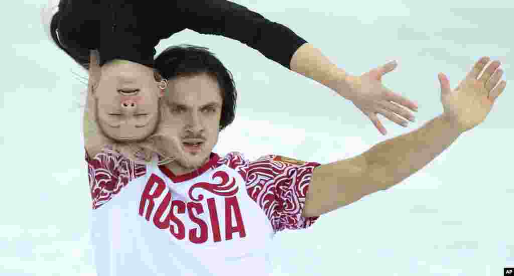 Russia's Tatiana Volosozhar and Maxim Trankov practice their routine at the figure stating practice rink ahead of the 2014 Winter Olympics, Feb. 5, 2014.